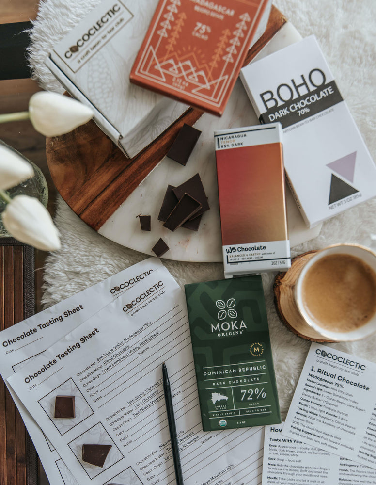 Chocolate tasting kit with 4 chocolate bars, chocolate pieces and a pen