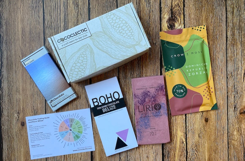 4 chocolate bars, a chocolate box and a chocolate tasting flavor wheel